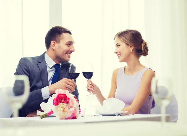 Jovem casal com copos de vinho no restaurante — Fotografia de Stock