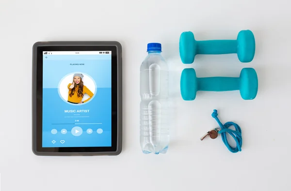 Tablet pc, dumbbells, whistle and water bottle — Stock Photo, Image