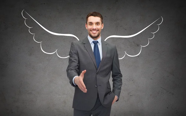 Happy businessman with angel wings over gray — Stock Photo, Image