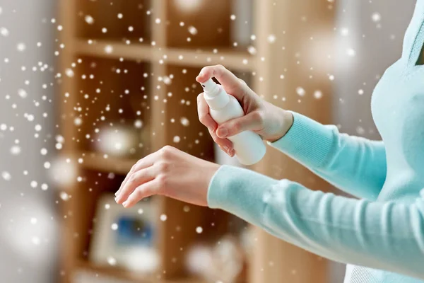 Close up of woman spraying hand sanitizer — Stock Photo, Image