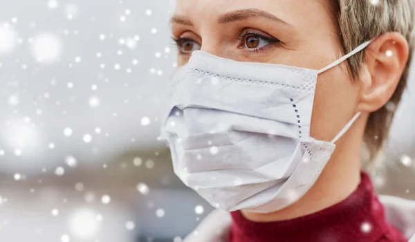 Young woman wearing protective medical mask — Stock Photo, Image