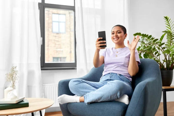 Woman with smartphone having video call at home — Stock Photo, Image