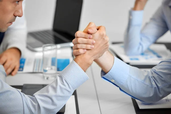 Close up of businesspeople arm wrestling at office — Stock Photo, Image