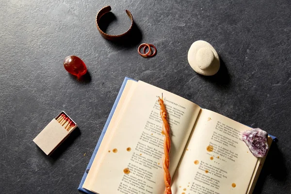 Libro mágico, vela de cera, fósforos y piedras preciosas — Foto de Stock