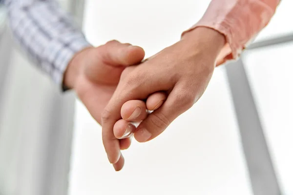 Close up of happy couple holding hands at home — Stock Photo, Image