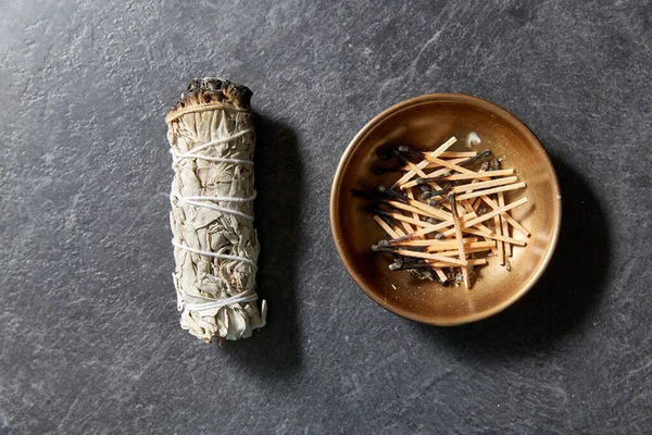 White sage and cup with burnt matches — Stock Photo, Image