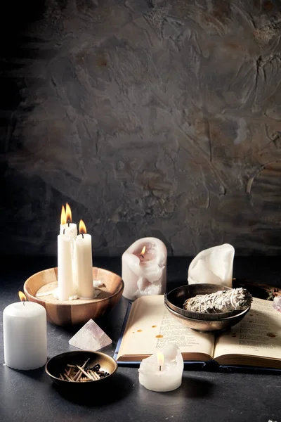 Magic book, sage, burning candles and ritual staff — Stock Photo, Image