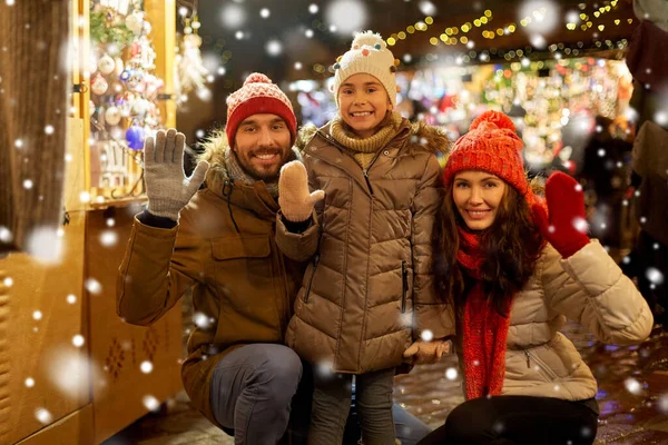 Щаслива сім'я махає руками на різдвяному ринку — стокове фото