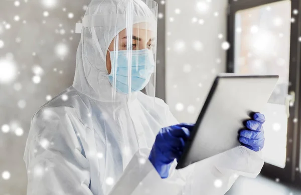 Doctor in protective wear with tablet computer — Stock Photo, Image
