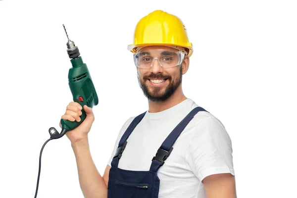 Happy male worker or builder in helmet with drill — Stock Photo, Image
