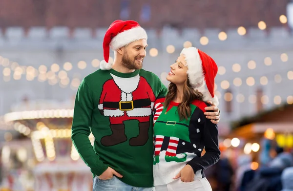 Happy couple in ugly sweaters on christmas — Stock Photo, Image