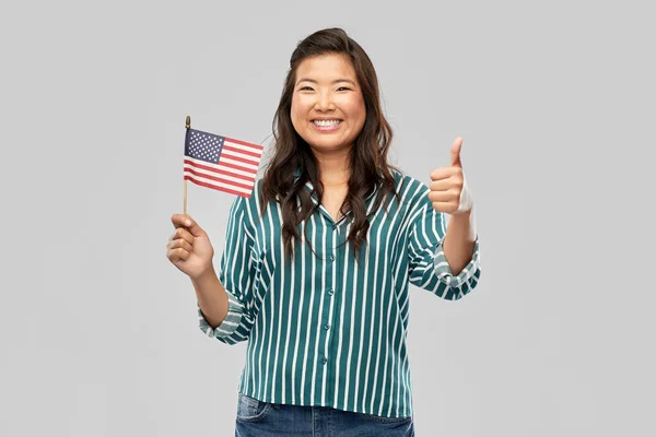 Azjatycka kobieta z flagą Ameryki pokazuje kciuki w górę — Zdjęcie stockowe