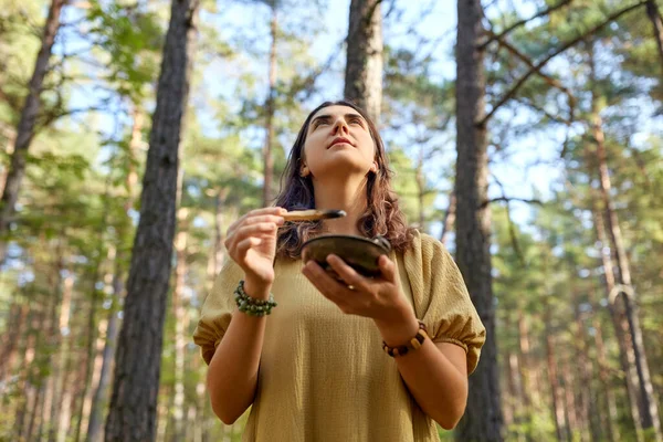 Woman or witch performing magic ritual in forest — Stock Photo, Image