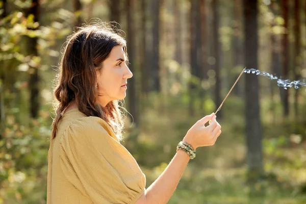 Woman or witch performing magic ritual in forest — Stock Photo, Image