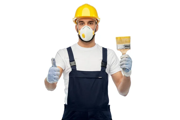 Byggare i respirator med pensel visar tummen upp — Stockfoto