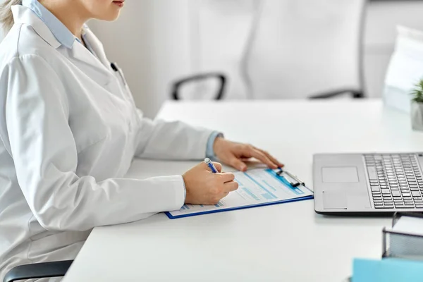 病院でノートパソコンや医療報告書を持っている医者は — ストック写真