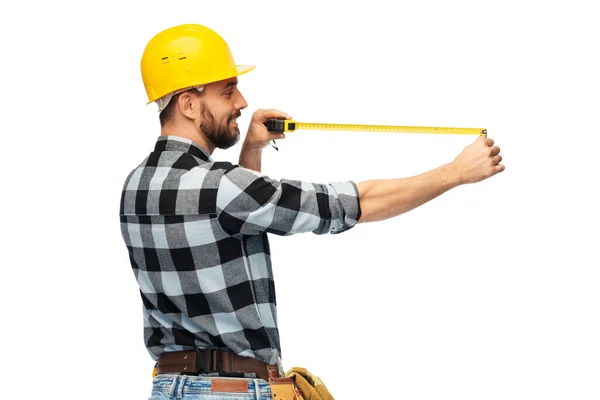 Happy male worker or builder in helmet with ruler — Stock Photo, Image