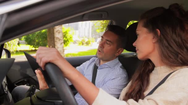 Woman and driving school instructor talking in car — Stock Video