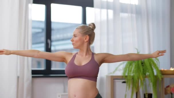Happy pregnant woman doing yoga at home — Stock Footage Happy pregnant woman doing yoga at home Royalty Free Stock Video