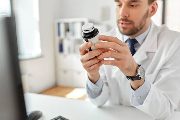 Smiling male doctor with medicine at hospital — Stock Photo, Image