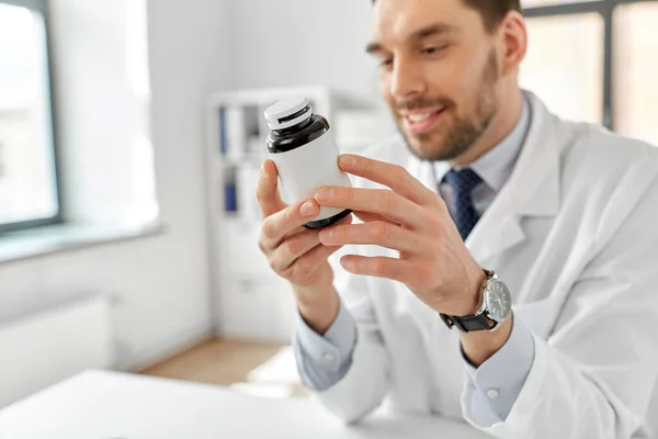 Smiling male doctor with medicine at hospital — Stock Photo, Image