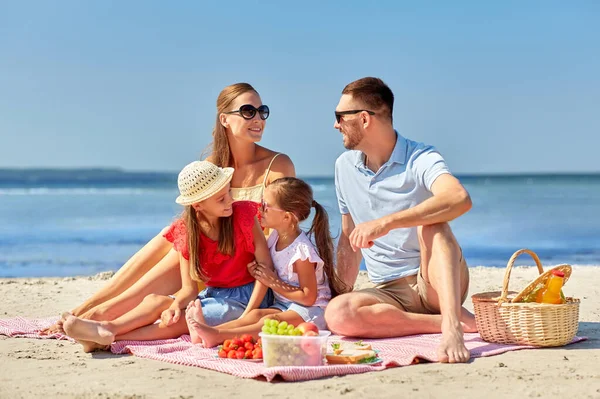 Familia feliz teniendo picnic en la playa de verano —  Fotos de Stock