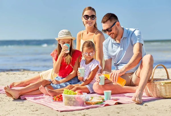 Glückliche Familie beim Picknick am Sommerstrand — Stockfoto