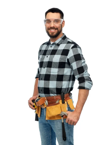 Happy male worker or builder with tool belt — Stock Photo, Image