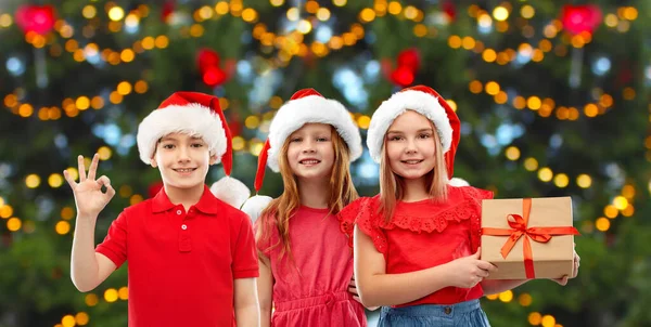 Szczęśliwy uśmiech dzieci z prezentem świątecznym — Zdjęcie stockowe