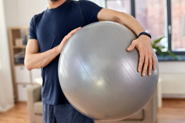 Close up of man with fitness ball at home — Stock Photo, Image