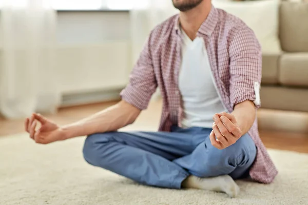 close up of man meditating at home