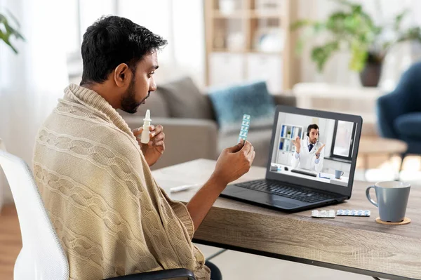Sick man having video call with doctor on laptop — Stock Photo, Image