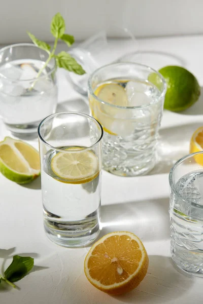 Bicchieri con acqua al limone e menta piperita in tavola — Foto Stock