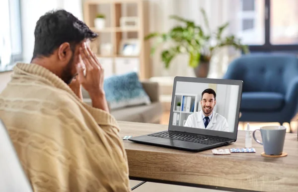 Sick man having video call with doctor at home — Stock Photo, Image