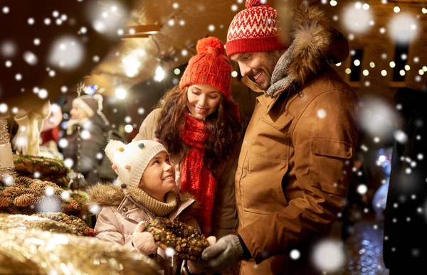 Szczęśliwy rodzinny buing wieniec na rynku Bożego Narodzenia — Zdjęcie stockowe