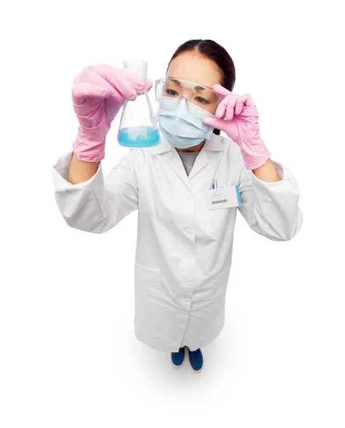 Asian doctor or scientist in mask with flask — Stock Photo, Image