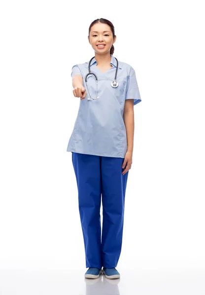 Smiling asian female doctor or nurse in uniform — Stock Photo, Image