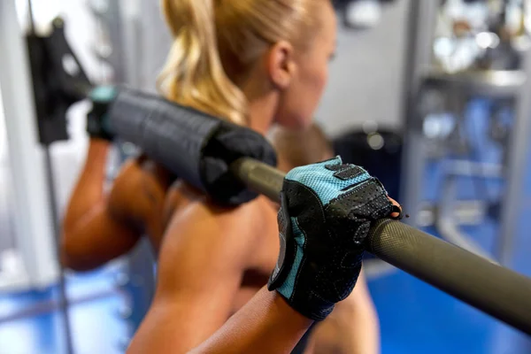 Close up of woman exercising with bar in gym — Stock Photo, Image