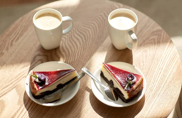 Pieces of chocolate cake on wooden table — Stock Photo, Image