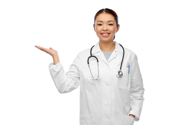 Asian female doctor holding something on hand — Stock Photo, Image