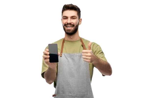 Barman feliz mostrando smartphone e polegares para cima — Fotografia de Stock
