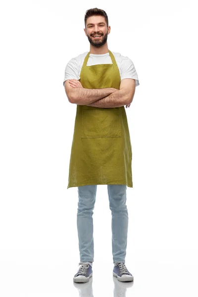 Blije barman of ober in schort met gekruiste armen — Stockfoto