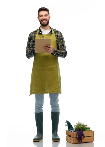 Glad trädgårdsmästare med skrivskiva med trädgårdsredskap — Stockfoto