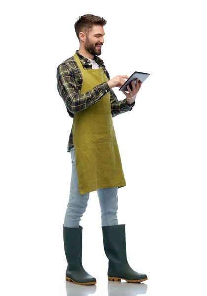 Happy male gardener or farmer with tablet pc — Stock Photo, Image