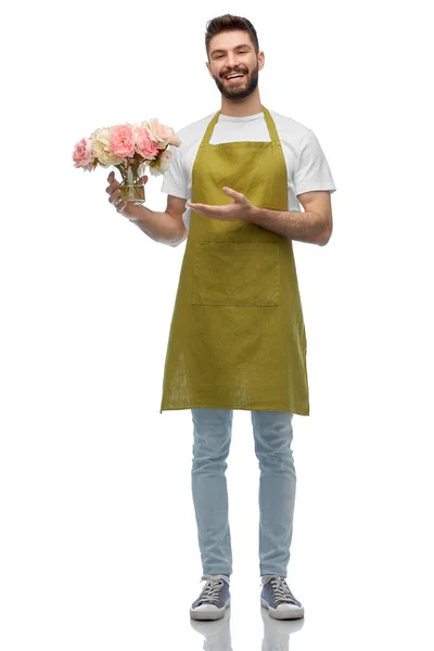 Happy smiling male gardener with flowers in vase — Stock Photo, Image