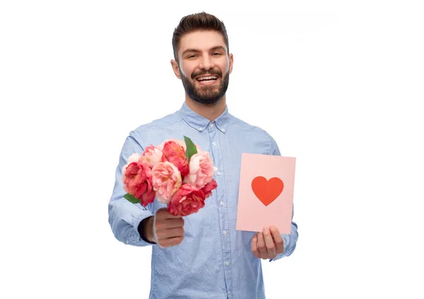 Glücklicher Mann mit Blumen und Valentinstag-Karte — Stockfoto