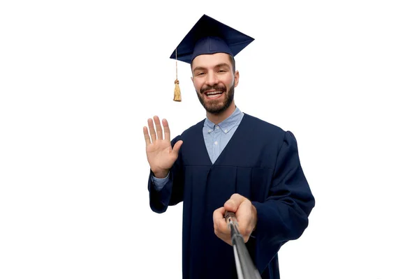 Male graduate student taking selfie with monopod — Stock Photo, Image