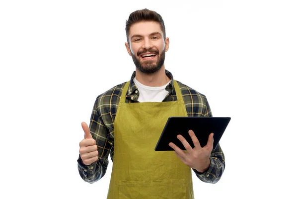 Glücklicher Gärtner oder Bauer mit Tablet-PC — Stockfoto