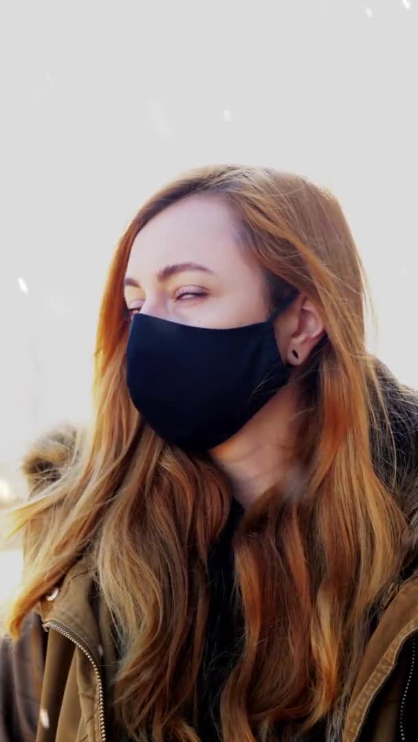 Woman wearing reusable protective mask in winter — Stock Video