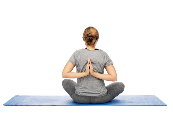 Woman doing reverse prayer pose on mat — Stok fotoğraf